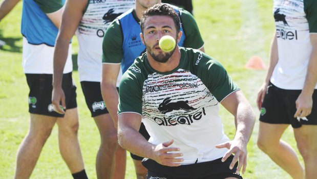 On the ball: South Sydney star Sam Burgess at training this morning without incoming coach Wayne Bennett.