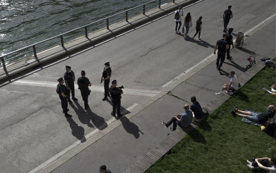 French police work to control people on the Seine river banks in Paris on March 31.