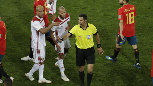 'Serious referee errors': Morocco's Karim El Ahmadi (8) talks to referee Ravshan Irmatov after the match between Spain and Morocco.