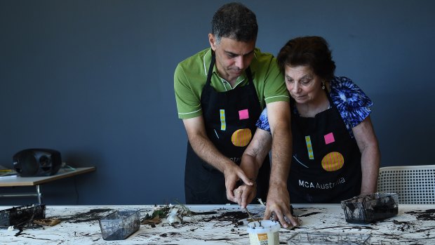 Anne Latimer, 76, who is living with a form of dementia, paints with her son and carer David Latimer at the MCA.