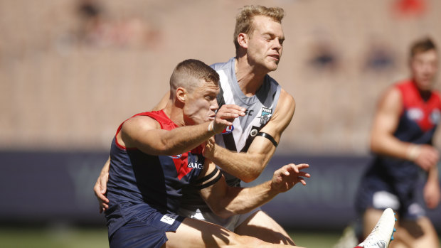 Port Adelaide star recruit Jack Watts lays a tackle on former teammate Jake Melksham.