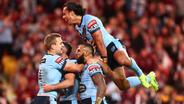 The Blues backline celebrate during game two at Suncorp Stadium.