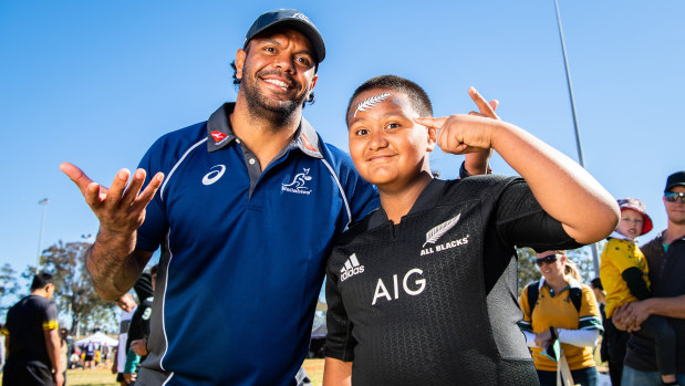 All fun and games: Kurtley Beale with a young All Blacks supporter at at fan day at Blacktown. on Sunday