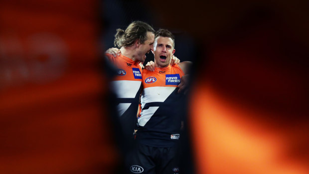 Phil Davis and Brett Deledio belt out the GWS Giants club song after beating the Western Bulldogs. 
