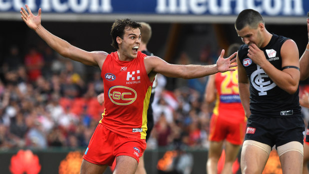 Eclipsed: Jack Bowes boots the winning goal for Gold Coast with just 13 seconds remaining on the clock.
