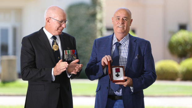 Governor-General David Hurley and Garry Ivory on behalf of the Sheean family during the Victoria Cross investiture ceremony on Tuesday.