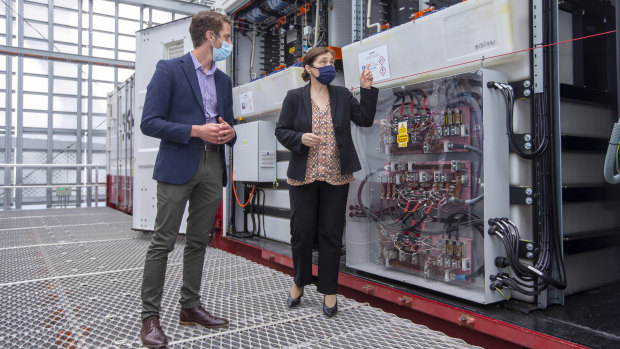 Scott Ferraro, program director, Net Zero Initiative showing batteries to Minister for Energy, Environment and Climate Change Lily D'Ambrosio. 