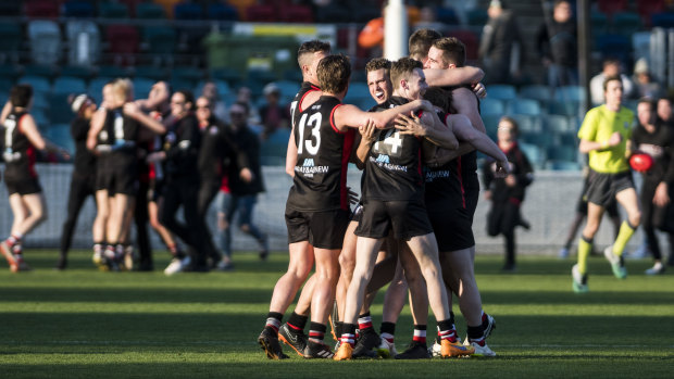 Ainslie Tricolours celebrate after winning the grand final.