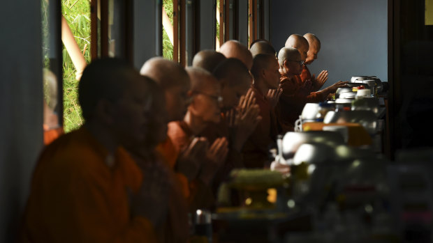 Female monks during a blessing before starting breakfast at the Songdhammakalyani Monastery. 