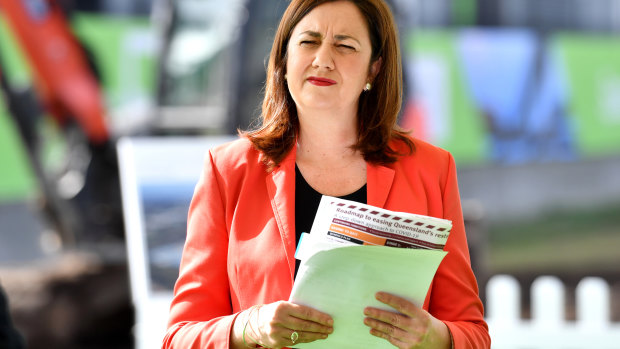 Queensland Premier Annastacia Palaszczuk holding her "roadmap to recovery" at a press conference on Thursday morning. 
