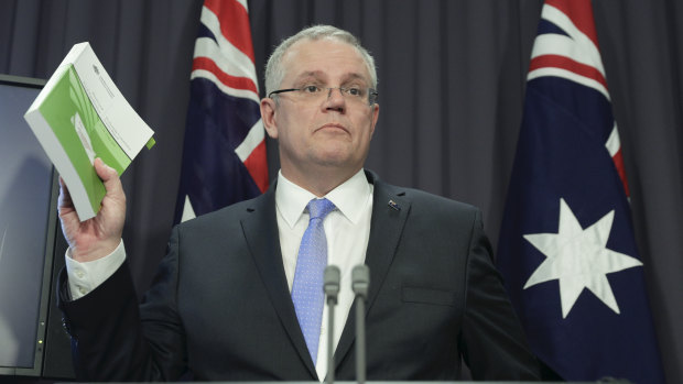 The Treasurer explains his new GST system at a press conference in Canberra.