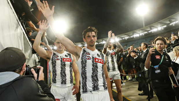 Collingwood captain Scott Pendlebury leads his teammates off the ground after the Magpies defeated Essendon.