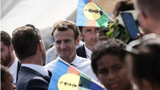 French President Emmanuel Macron is surrounded by independence Kanak flags on Ouvea Island, off New Caledonia, on Saturday, May 5.