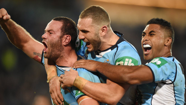 Tease: Boyd Cordner, Robbie Farah and Michael Jennings celebrate the former's try in game one.