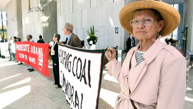 Adani protesters are seen occupying the foyer of the Queensland government headquarters at 1 William Street.