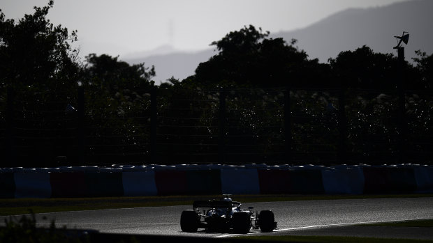 Lighting it up: Valterri Bottas pilots his Mercedes around the Suzuka track.