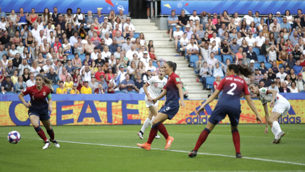 England's Jill Scott (right) watches as her shot at goal goes past Norway's defenders to score.