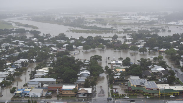 An aerial view of houses inundated with flood waters in Townsville on Monday. Hundreds of people are  still waiting for help and evacuation centres are filling up fast.