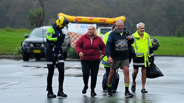 Rescued: Oaxley Island residents Liz Brennan, her husband Paul Brennan (second from right) and a neighbour (right).