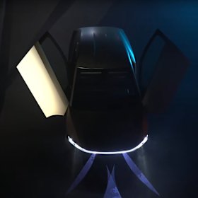 A Tesla robotaxi with two gull-wing doors.