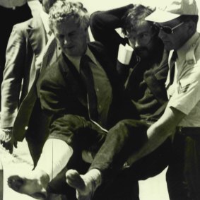February 15, 1977: Edwin John Eastwood is carried from a plane at Essendon Airport after being shot in the leg and captured.