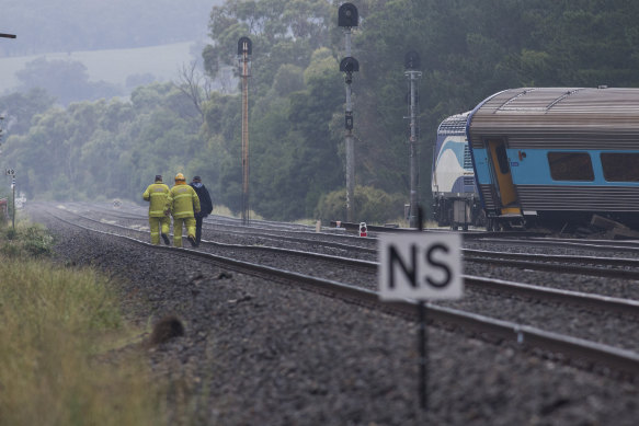 Firefighters scour the scene of the train derailment at Wallan.