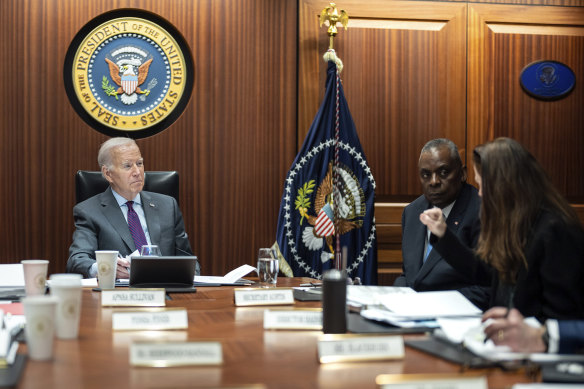  President Joe Biden on the Situation Room at the White House in Washington, as Defence Secretary Lloyd Austin listens.