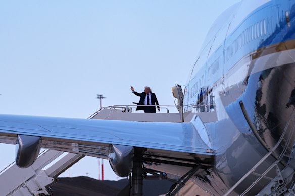 President Donald Trump and first lady Melania Trump wave before they board Air Force One at Leonardo da Vinci International Airport following the funeral.