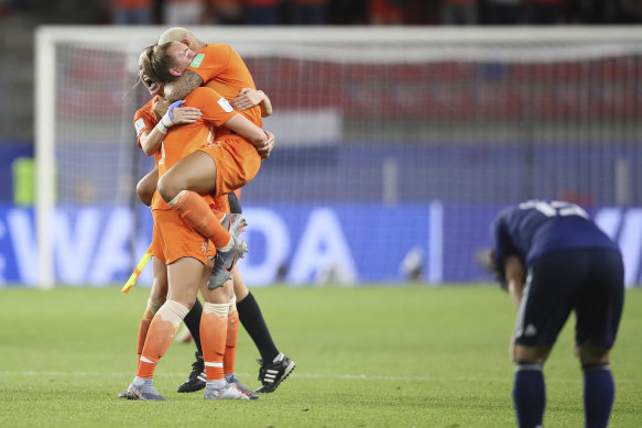 Agony and ecstasy: Dutch players celebrate their win as their Japanese counterparts are sent crashing out of the World Cup.
