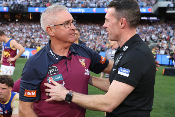 Chris Fagan congratulates Magpies counterpart Craig McRae, himself a three-time premiership player at the Lions.