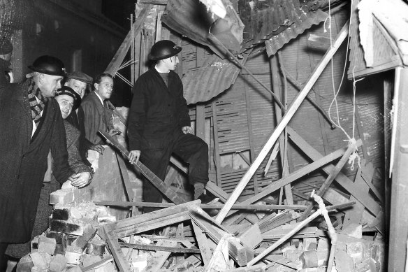 NES workers stand in the remains of the kitchen and laundry of a Bellevue Hill house, which had received a direct hit on June 8, 1942.
