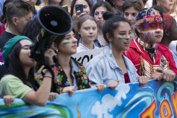 Swedish activist and student Greta Thunberg, centre, takes part in the Climate Strike, in Montreal on Friday.