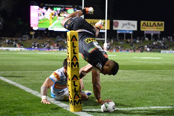 Head over heels: Brian To'o scores an acrobatic try against the Titans. 