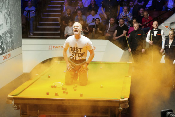 A ‘Just Stop Oil’ protester disrupts the World Snooker Championship in Sheffield during April.