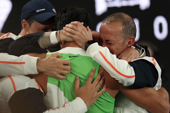 Alcaraz hugs his team following his Australian Open triumph.