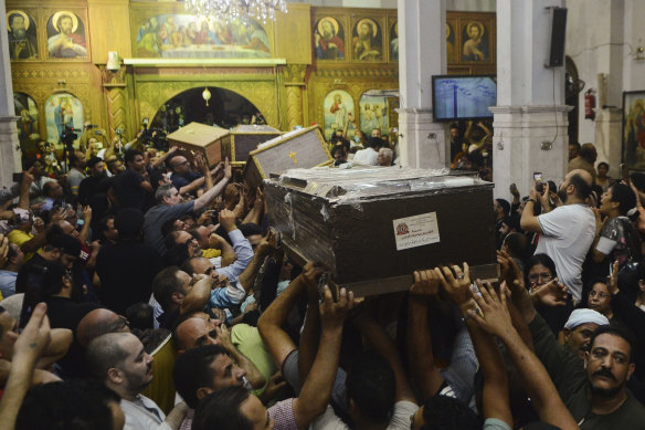 Mourners attend a memorial service for victims of the fire at Abu Sefein church in Cairo.