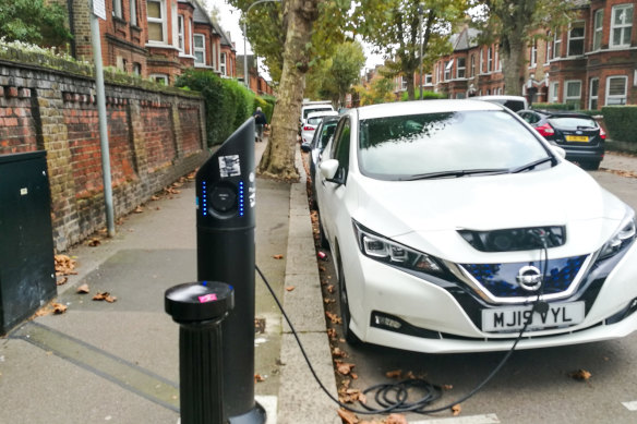 An electric car being charged on a residential street in London.