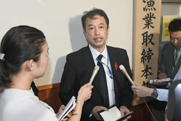 An official of the Japanese Fisheries Agency speaks to media following the collision.