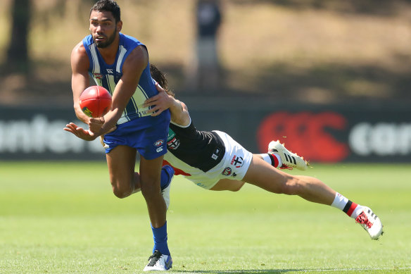 North Melbourne’s Tarryn Thomas looks to dispose of the ball.