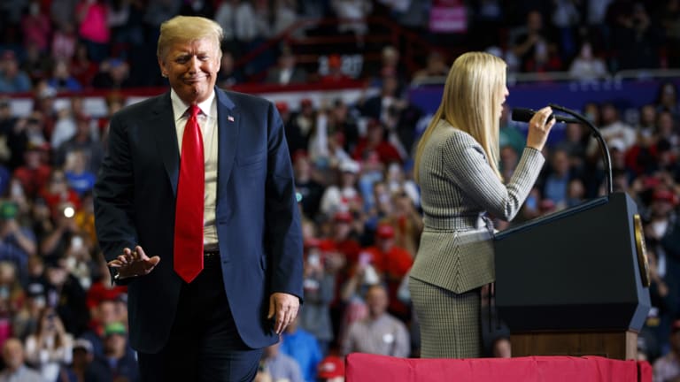 President Donald Trump wavesas his daughter Ivanka speaks at a rally. He turned Clinton's use of a private email address against her.