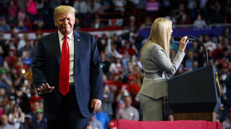 President Donald Trump wavesas his daughter Ivanka speaks at a rally. He turned Clinton's use of a private email address against her.