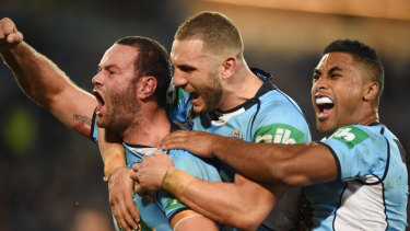 Tease: Boyd Cordner, Robbie Farah and Michael Jennings celebrate the former's try in game one.