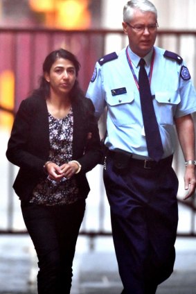 Sofia Sam led into court by a prison guard during the trial.