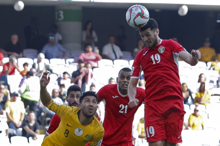 Head for heights: Anas Bani Yaseen heads home the winning goal for Jordan.