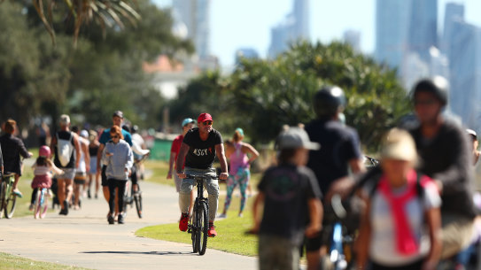 GOLD COAST, AUSTRALIA - MAY 02: People ride bikes along Miami foreshore on May 02, 2020 in Gold Coast, Australia. The Queensland government has eased COVID-19 lockdown measures in response to a decline in coronavirus cases across the state. From Saturday 2 May, Queenslanders are allowed to leave their homes for recreational activities, such as motorbiking or boating, picnics, visiting national parks or going shopping for non-essential items. Social distancing must still be observed and people must stay within 50km of their principle residence. (Photo by Chris Hyde/Getty Images)