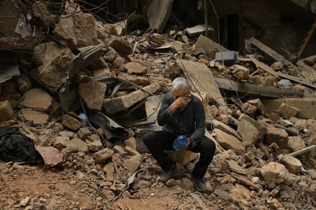 Salah, who witnessed the deadly Israeli airstrike, sits among the debris in Basta.