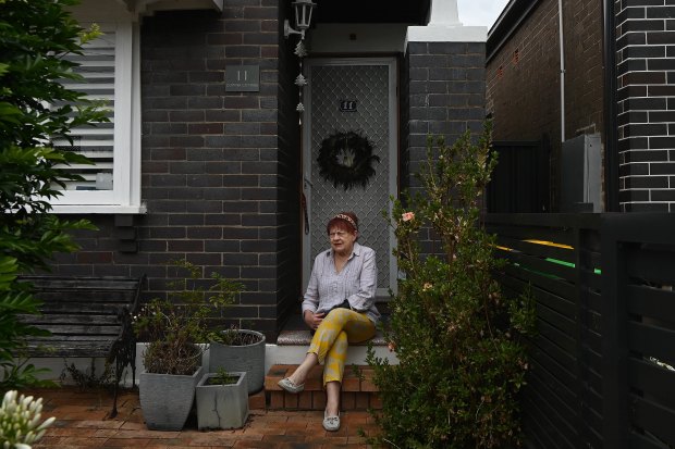 Caroline Gillham-Racz, 75, in front of her home in Campsie, where she has lived for 50 years. “They can take me out in a box,” she says.