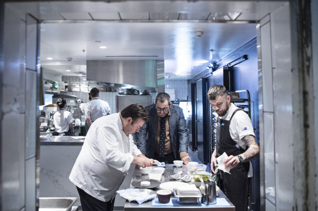 John Fink (centre) watches over as Peter Gilmore prepares a tasting menu
for the new restaurant. 