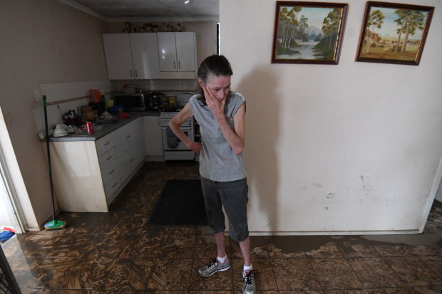 Sue Pollard becomes emotional as she takes in the damage to her Townsville home.