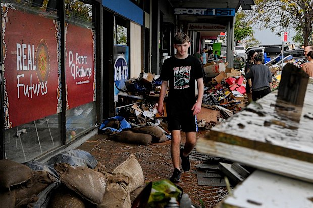 Locals start the clean-up on Manning Street in Taree.